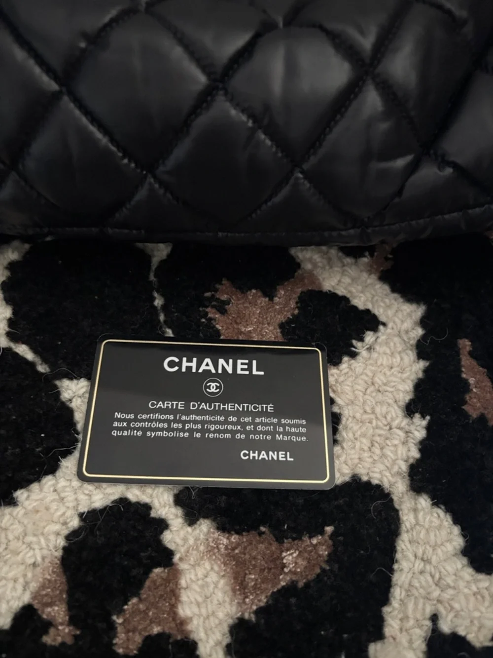 CHANEL Black Quilted Puffer Bag with Embossed CC Patch